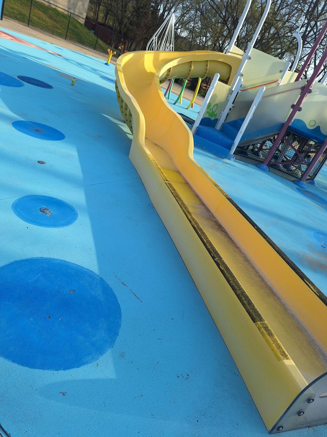 Yellow slide exterior after hand sanding and marine grade coating